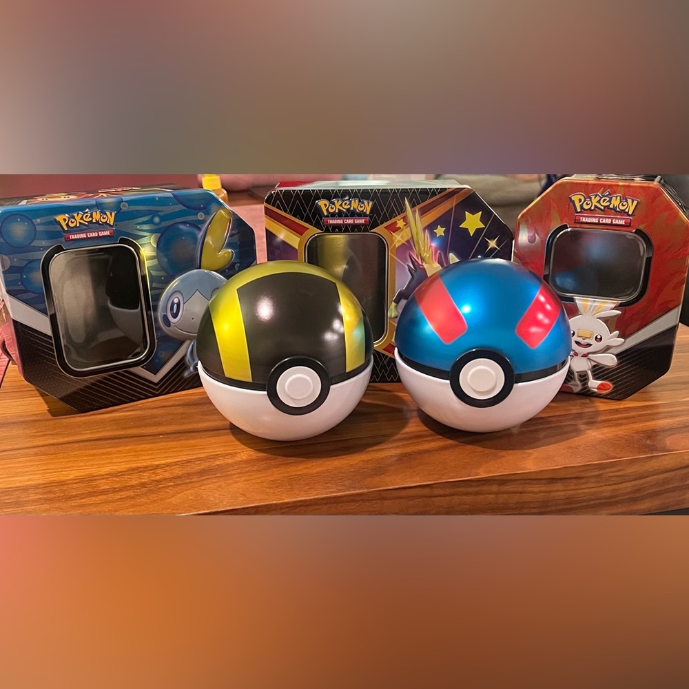 Poké Ball Toy Set And Three Tin Boxes. Cards not included. Small Dent.